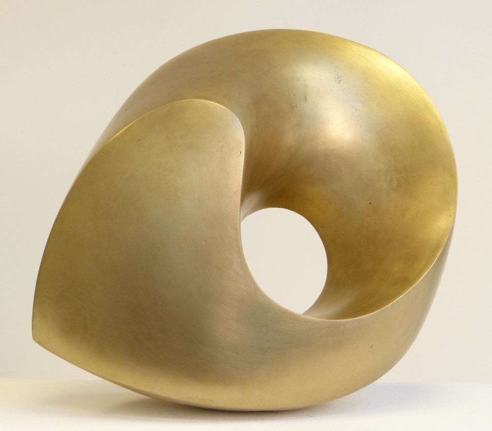 Abstract bronze sculpture with round forms and a golden shining surface.