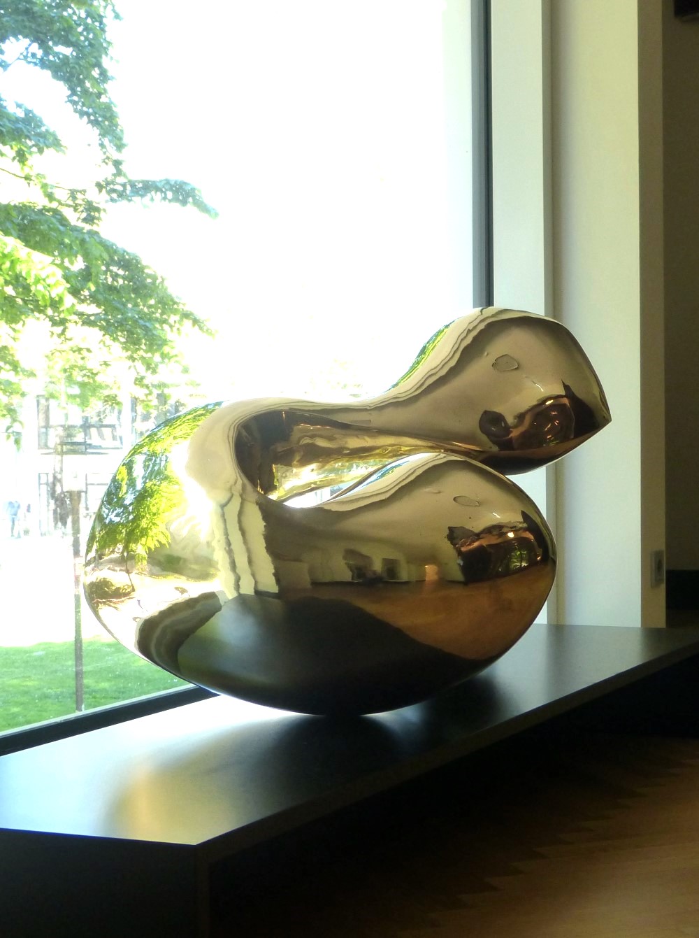 High polished abstract brass sculpture with smooth organic forms