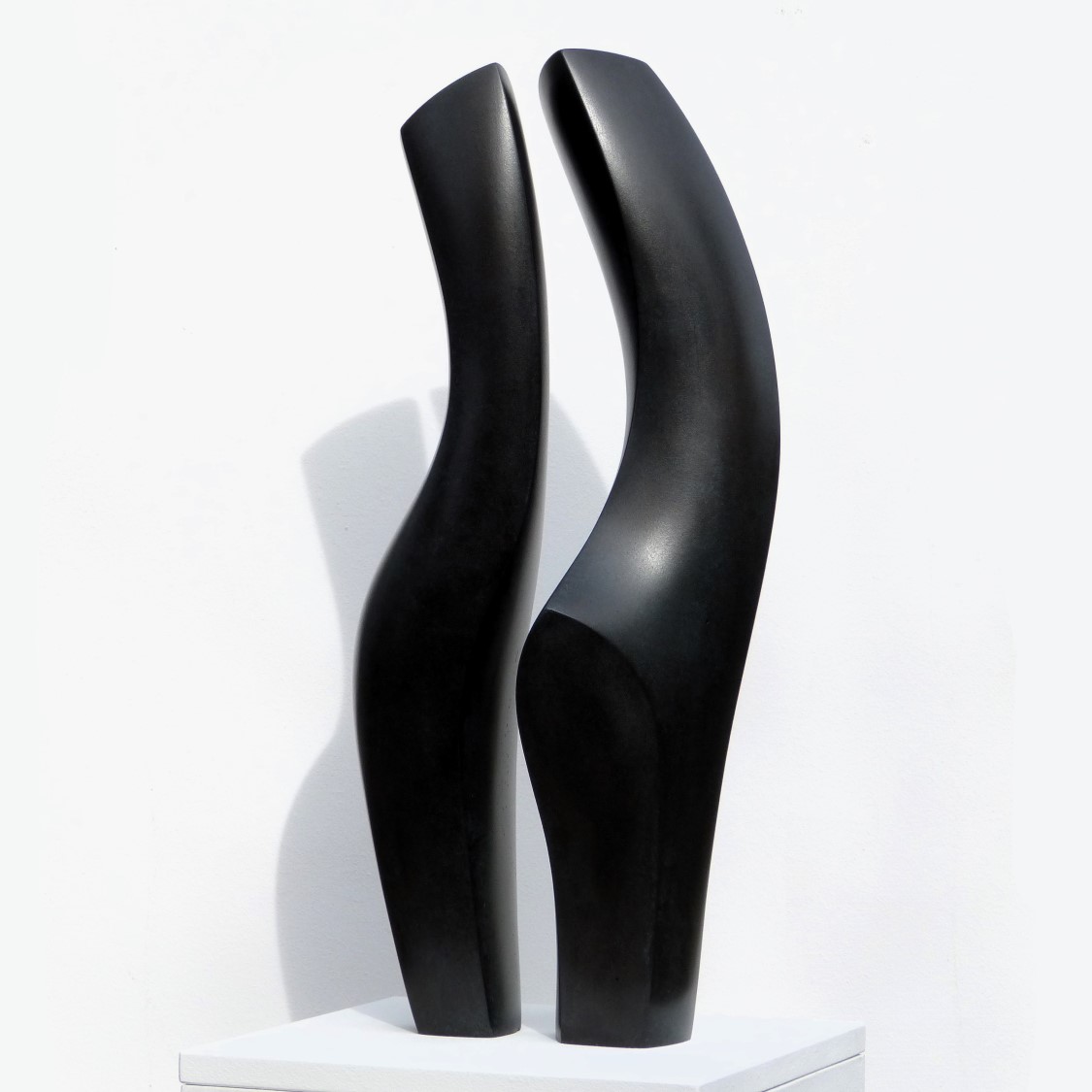 Black abstract two piece sculpture of a loving couple