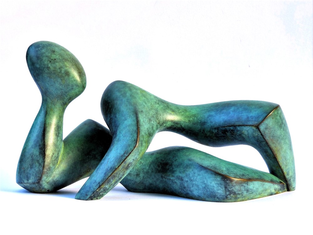 Sculpture of a lying human, abstract, green patinated