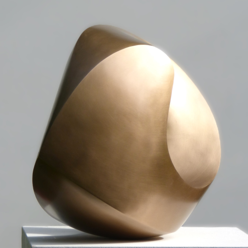 Abstract bronze sculpture with round forms and a golden shining surface.